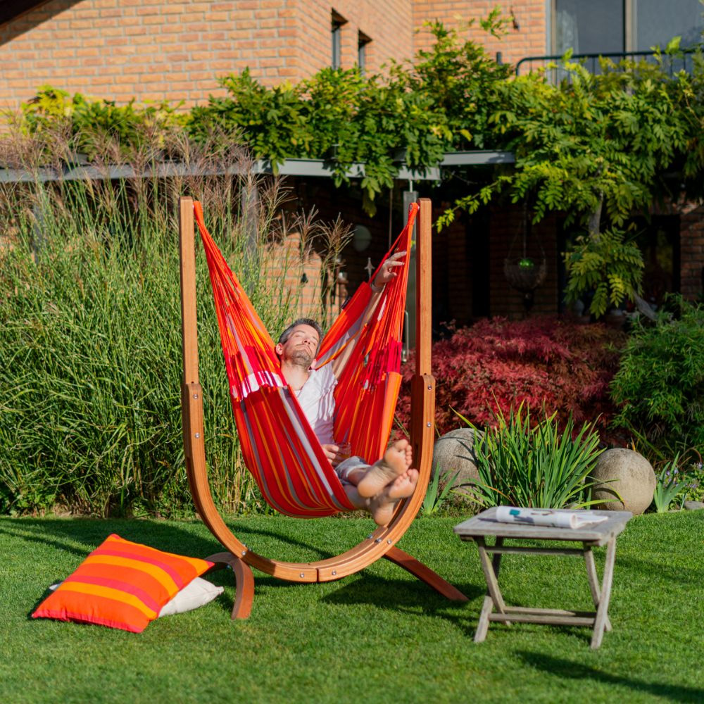Best Christmas gift ideas with a man lying on a hammock chair during the day, enjoying festive downtime and relaxed comfort.