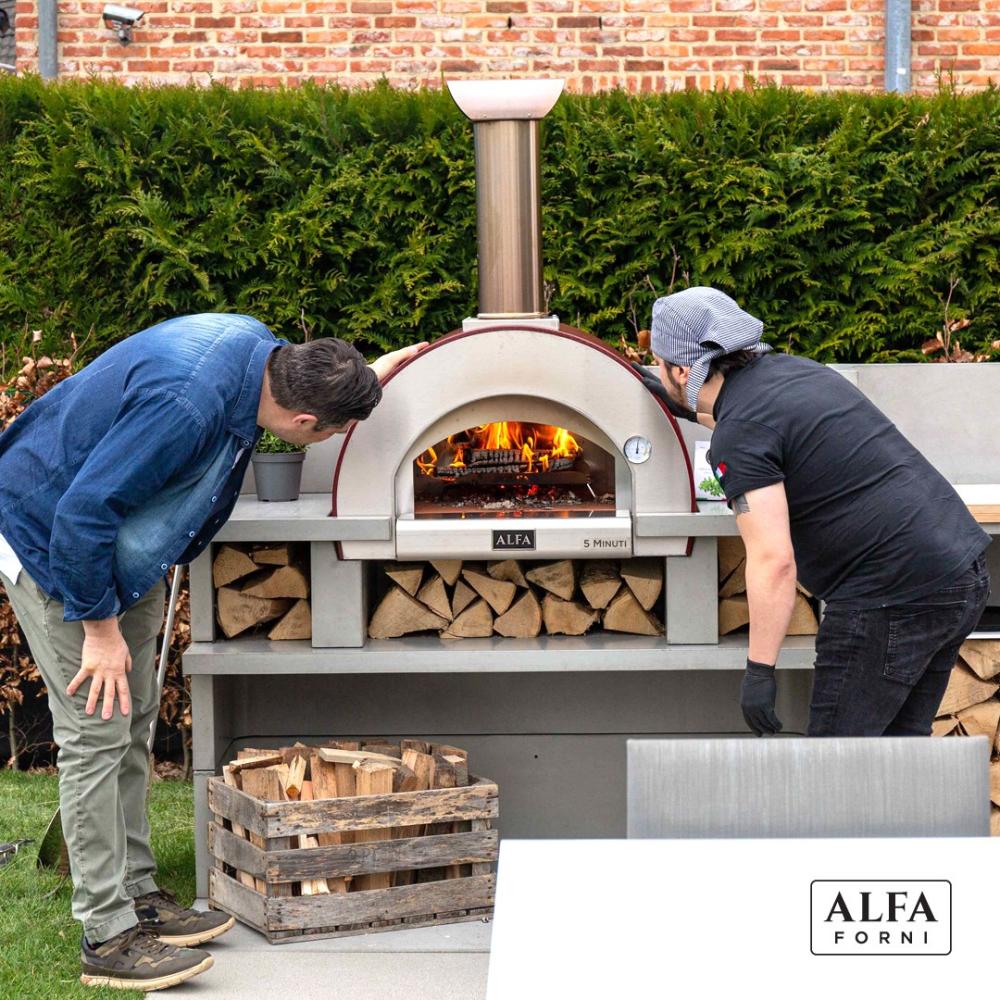 Baking bread at home using a wood-burning oven from Alfa Forni with steady heat control.