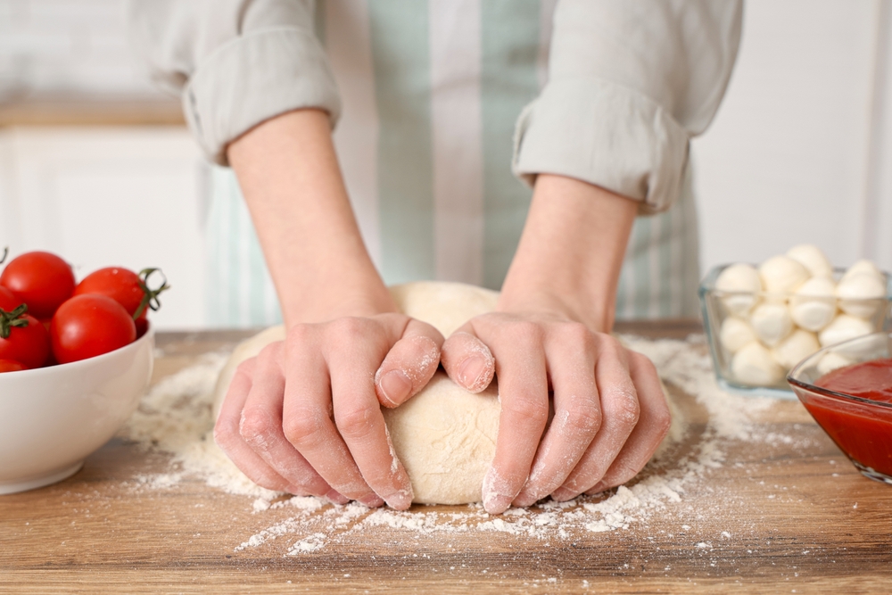 How to make pizza dough at home with proper kneading technique for consistent results. 