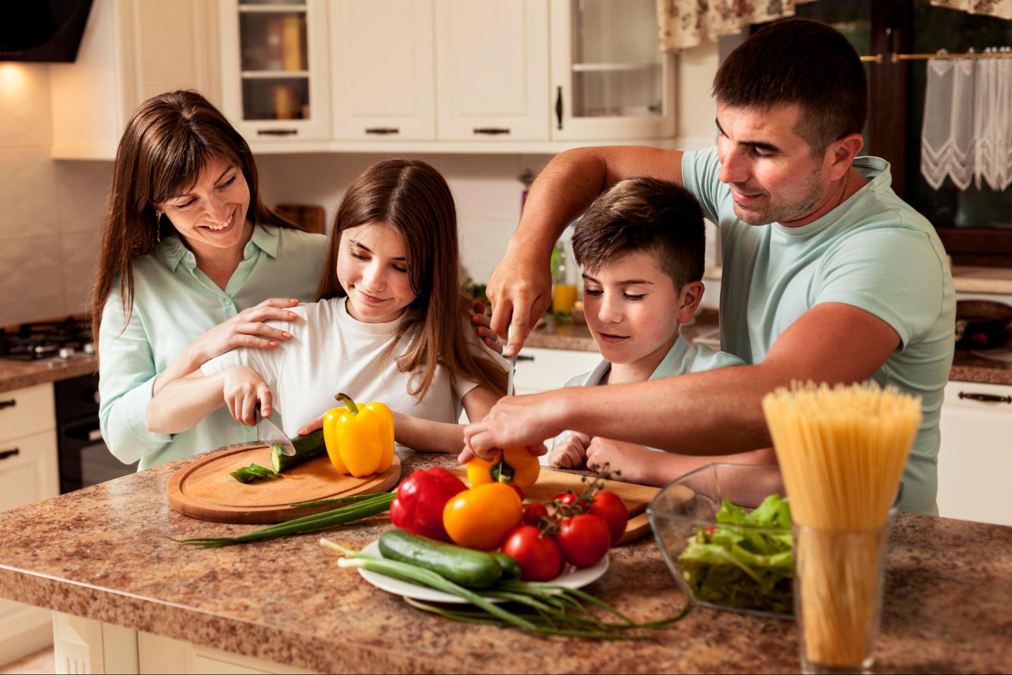 A family prepares dinner together in a cozy kitchen, using MVP appliances for a quick and easy home-cooked meal.