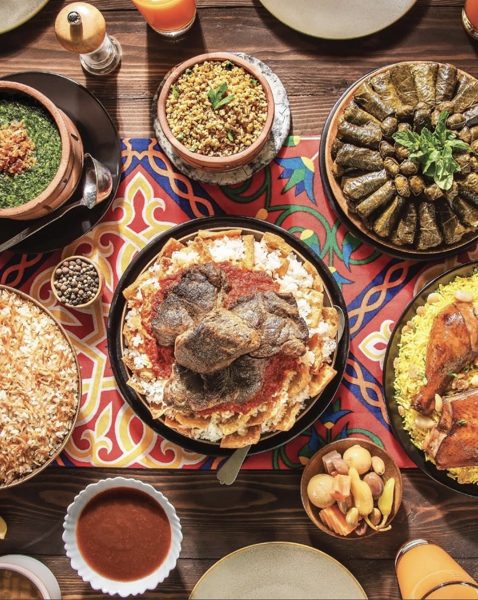 Assorted Mediterranean dishes including roasted meat, and stuffed leaves served as part of healthy oven dinner recipes at home.