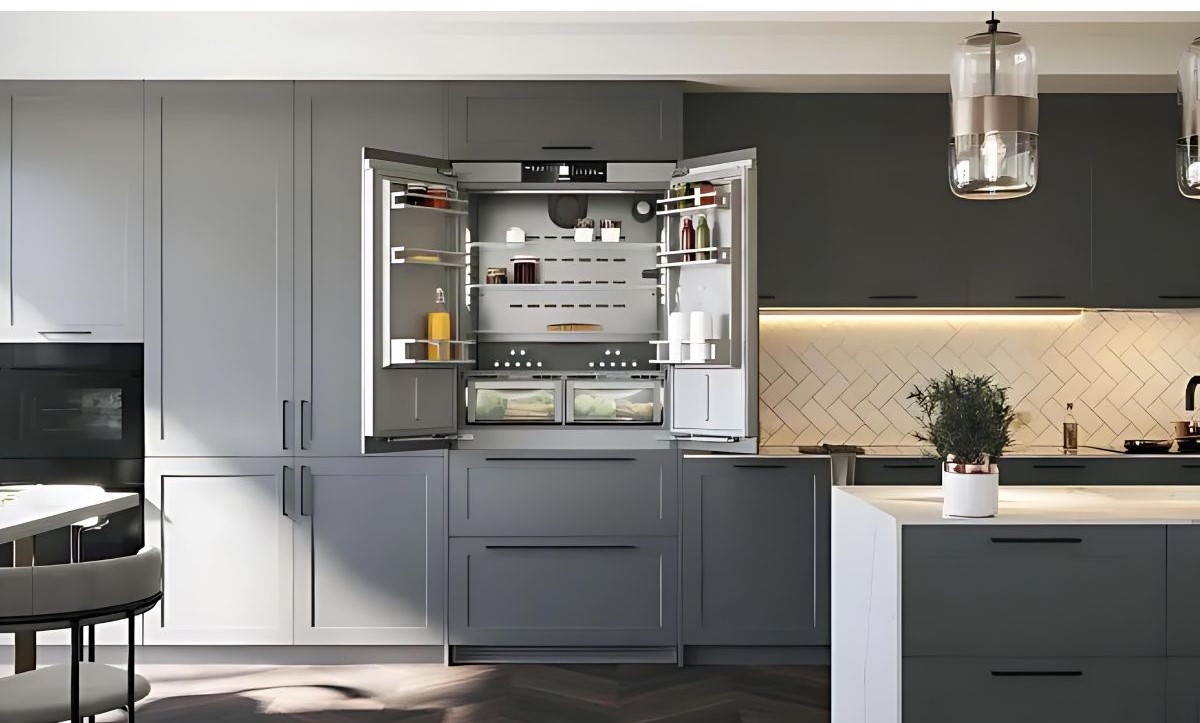 A modern kitchen with sleek gray cabinetry and an open refrigerator displaying organised shelves. Warm under-cabinet lighting adds a cozy feel.