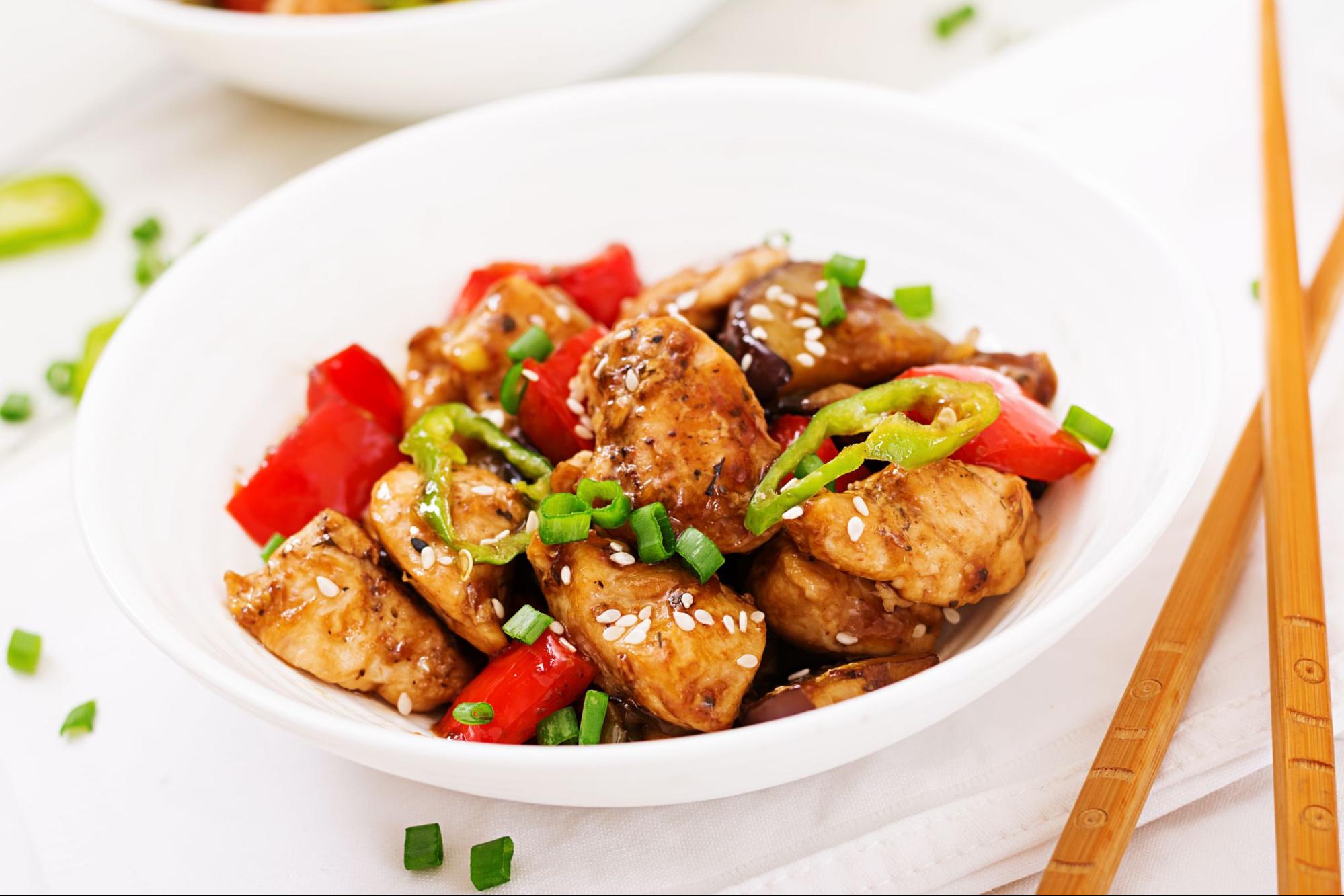 Teriyaki chicken stir-fry with colourful vegetables, glazed in sauce and served over steamed rice.