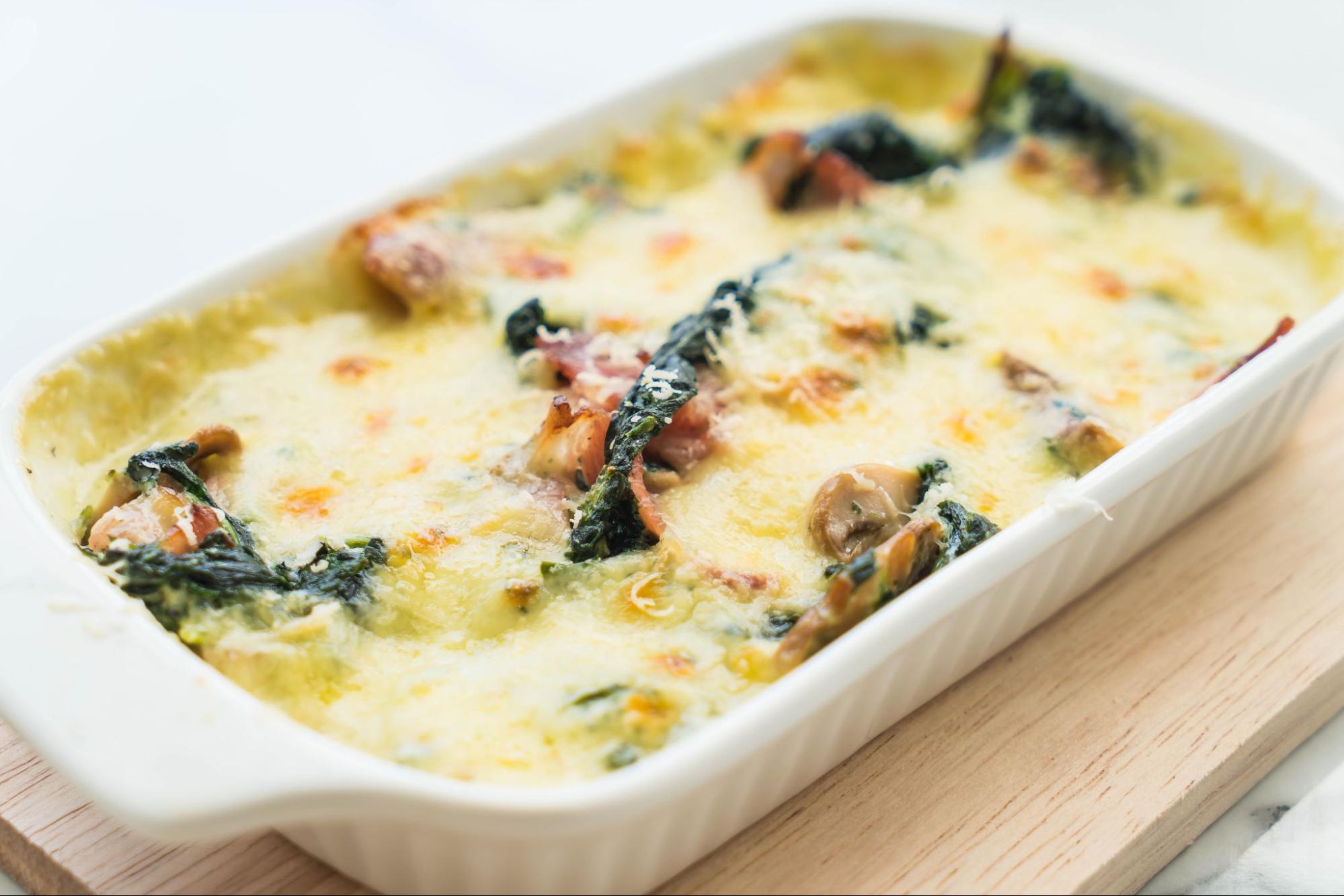 Creamy chicken and mushroom bake topped with melted cheese, served hot in a casserole dish.