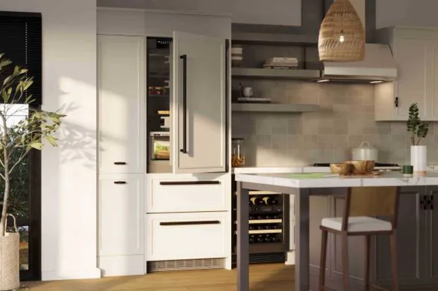 Modern kitchen with white cabinets, open fridge, and wine cooler. Sunlight highlights wooden floors, island with chair, and hanging wicker light. Cozy and inviting.